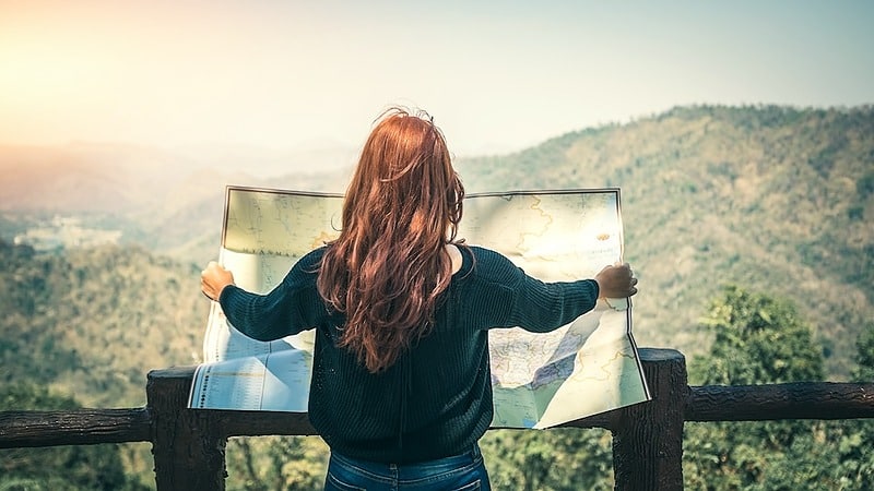 Woman reading map - Explorations Online